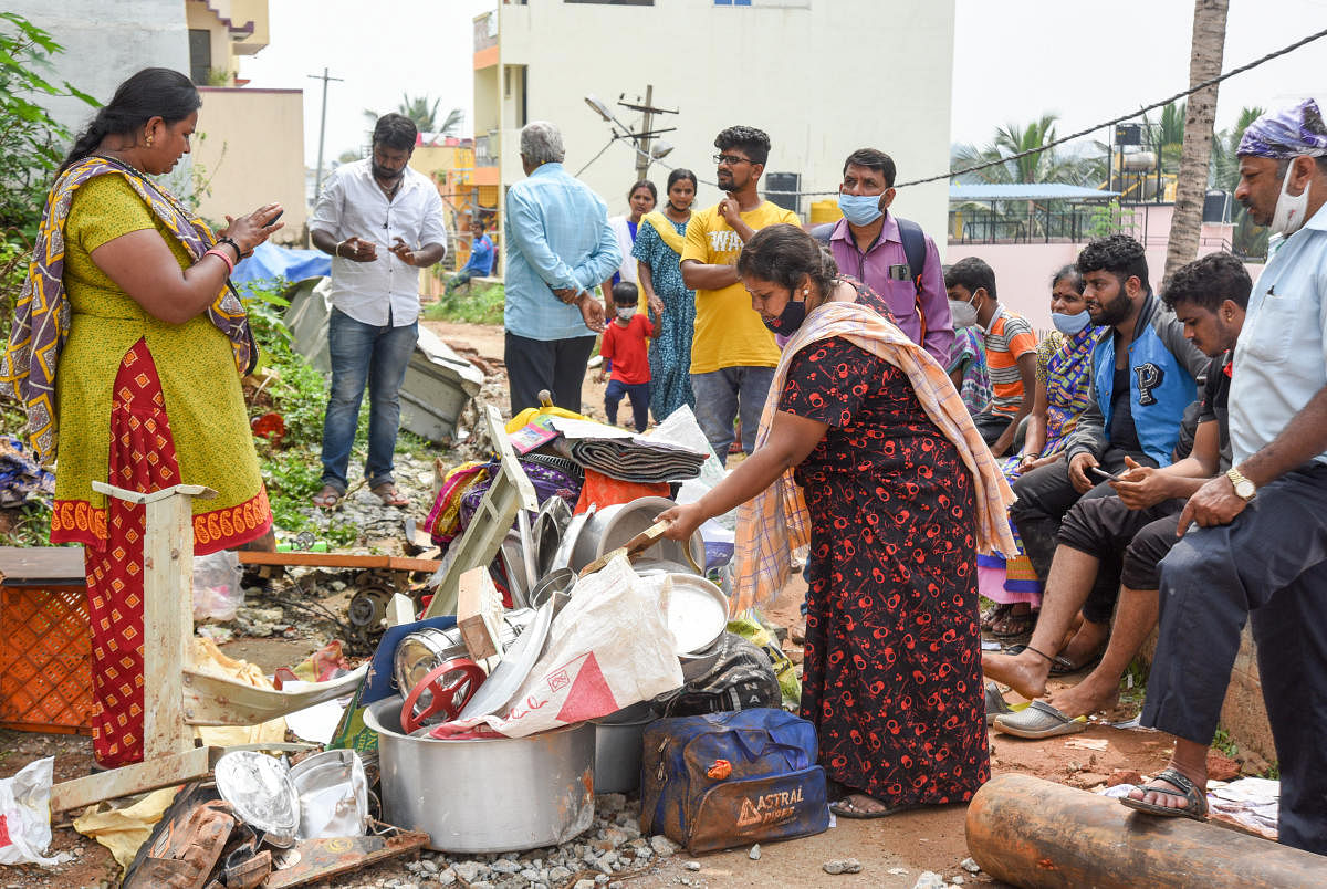 Residents trying to salvage their belongings. Credit: DH Photo