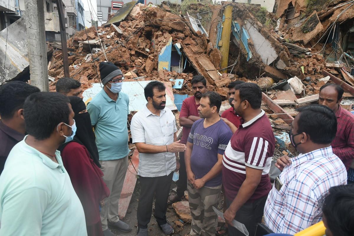 MLA L Nagendra inspects the collapsed house, on Ashoka Road, in Mysuru, on Thursday.
