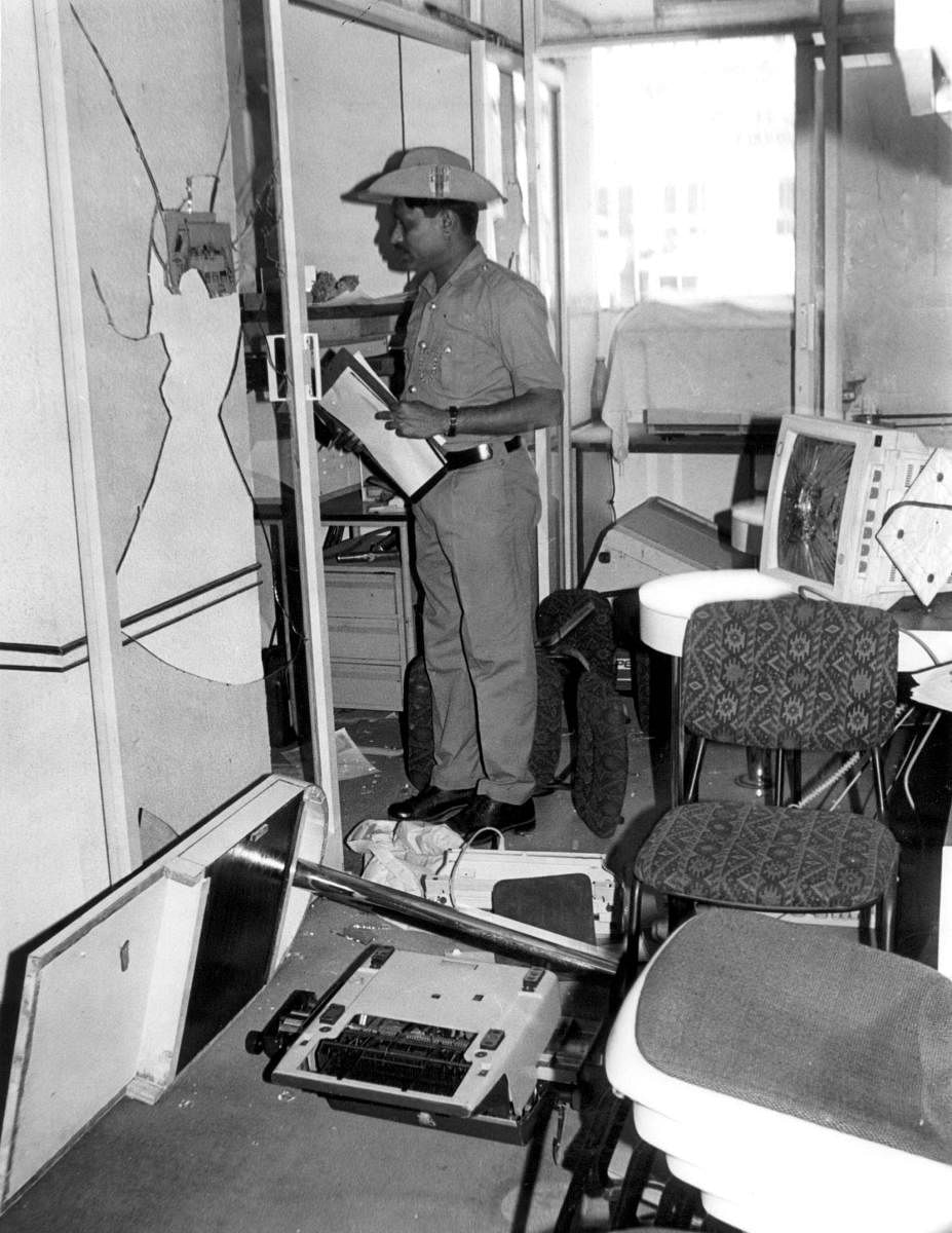 A policeman inspects the damage at the ABCL office in Bengaluru after it was attacked by unidentified persons in protest against the 1996 Miss World contest. Credit: DH File Photo
