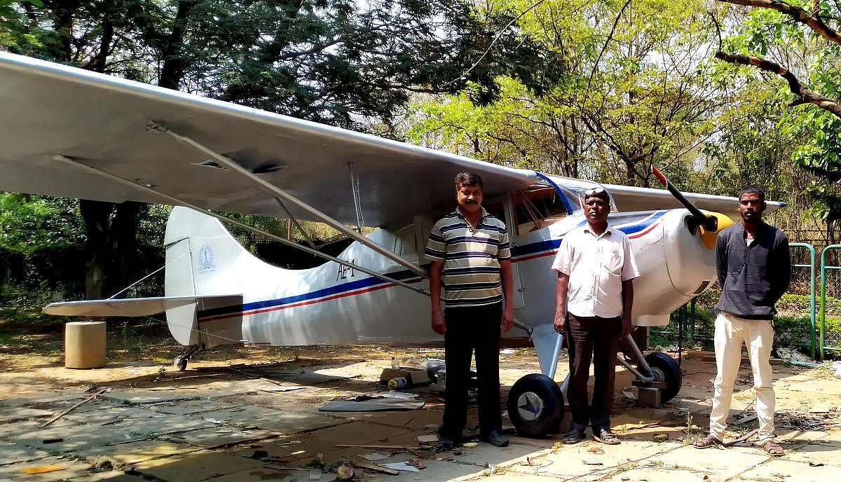 Sukumar, Babi Muralidhar and Manjunath P M from the tool and die-making trade have turned aircraft restorers. They are standing in front of IIS'c restored HAL Pushpak display aircraft which had badly degraded over the years in Bengaluru. 