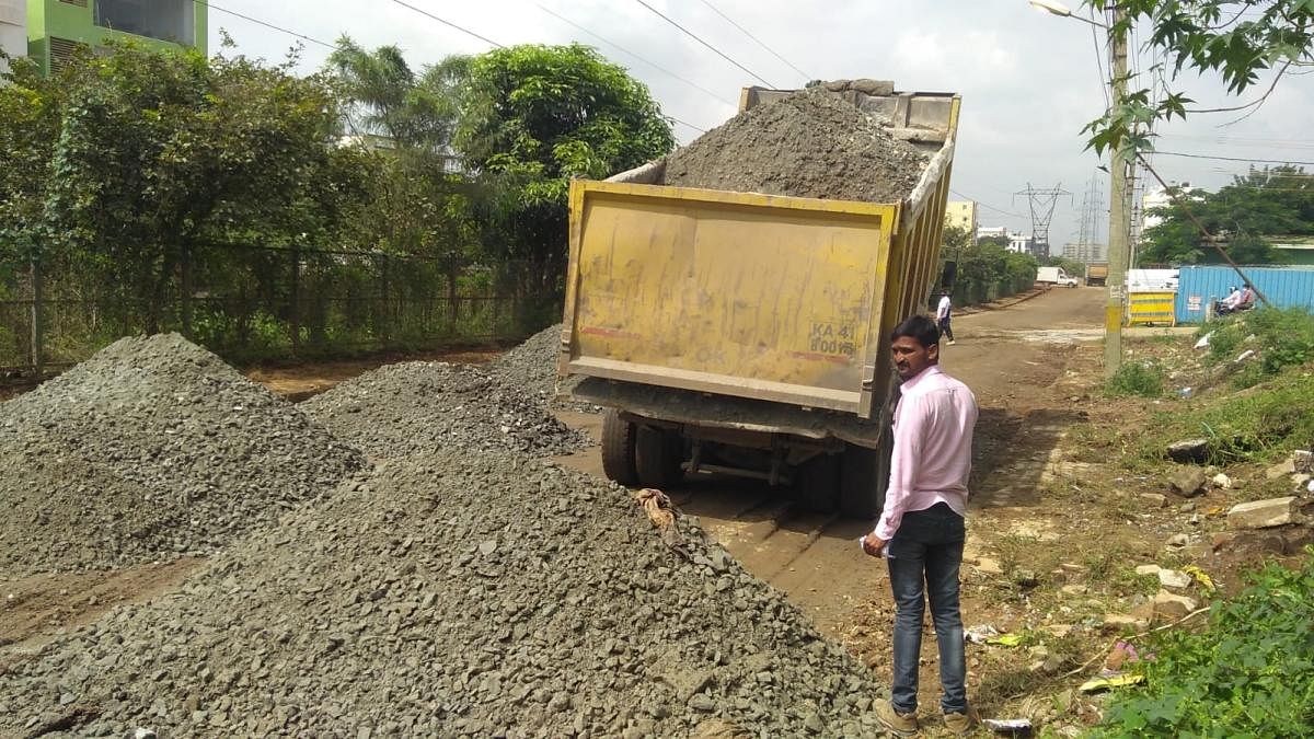 BDA contractors begin work to repair the damaged Anjanapura main road, off Kanakapura Road.