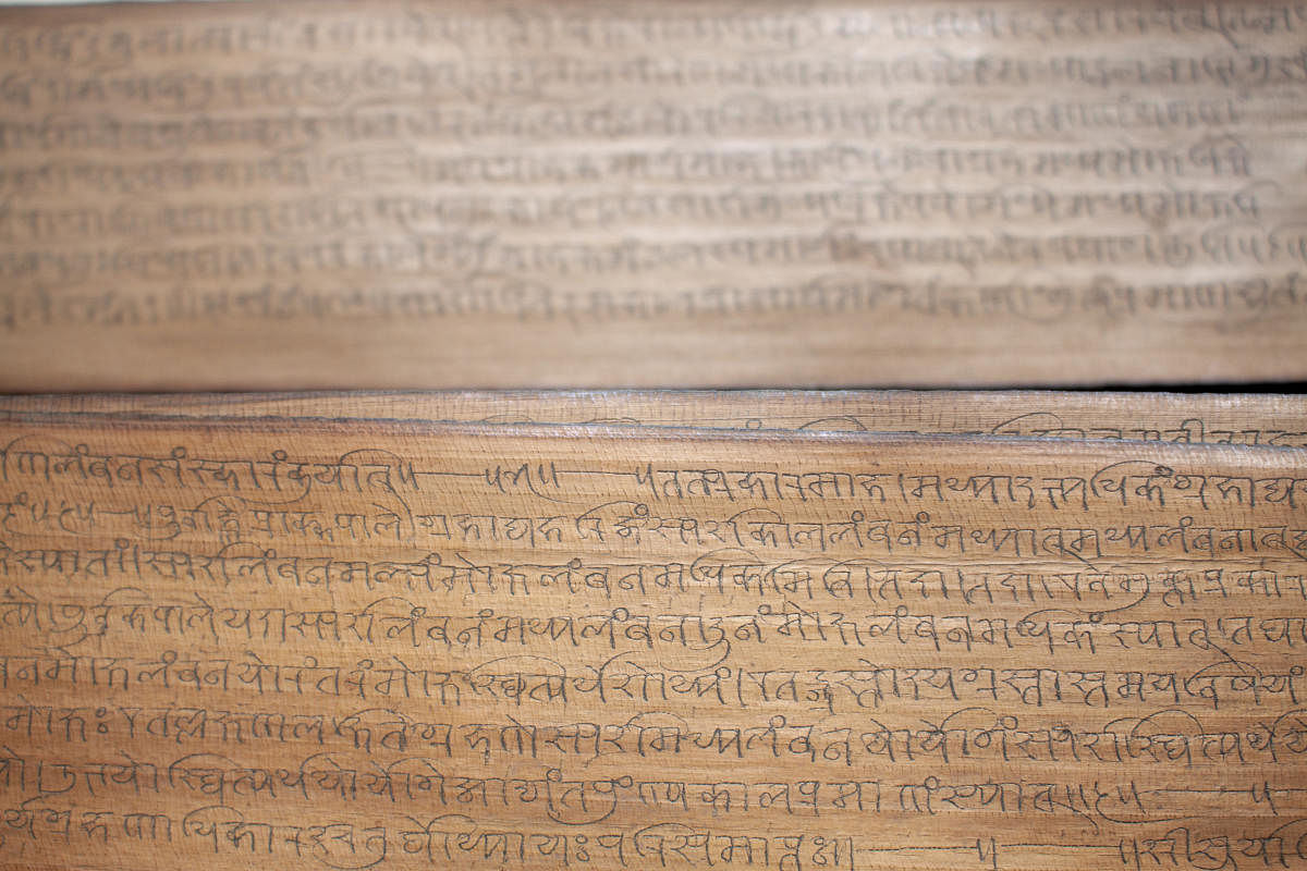 The palm leaf manuscripts are in the Nandinagari script, an ancient dialect of Kannada and Sanskrit; (top) The folios in the possession of Seetharam Javagal were actually astronomical documents.