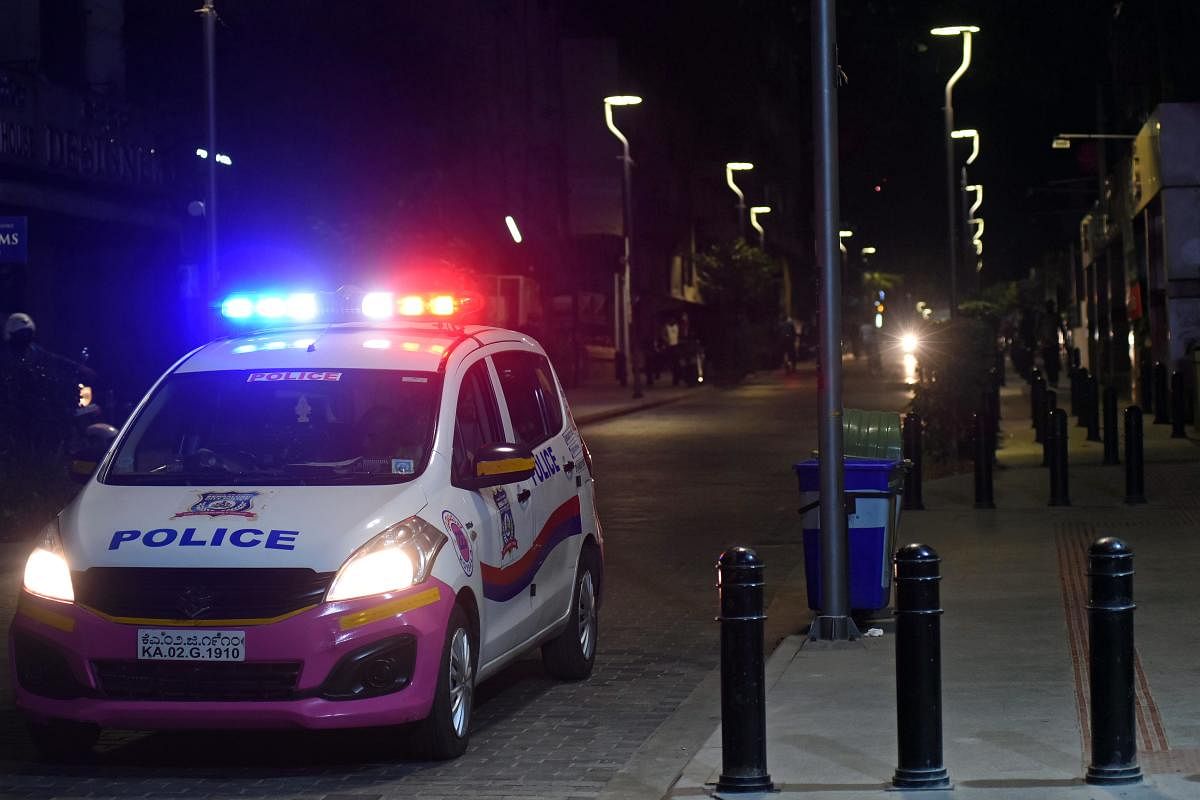A police car patrols Church Street as the weekend curfew kicked in. Credit: DH Photo