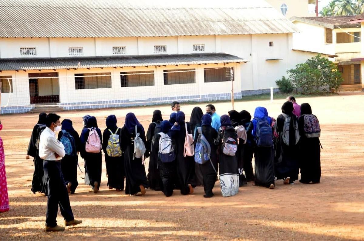 Students wearing Hijab interact with the principal of Government PU College in Kundapura. 