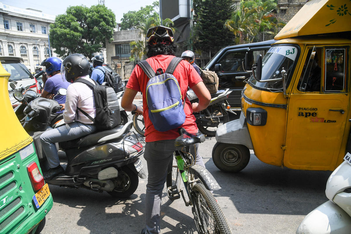The reporter was the only cyclist in a sea of cars, bikes, buses and trucks stuck in a traffic jam on M G Road in Bengaluru that day. He was met with incessant honking and close shaves. Credit: DH Photo/B H Shivakumar