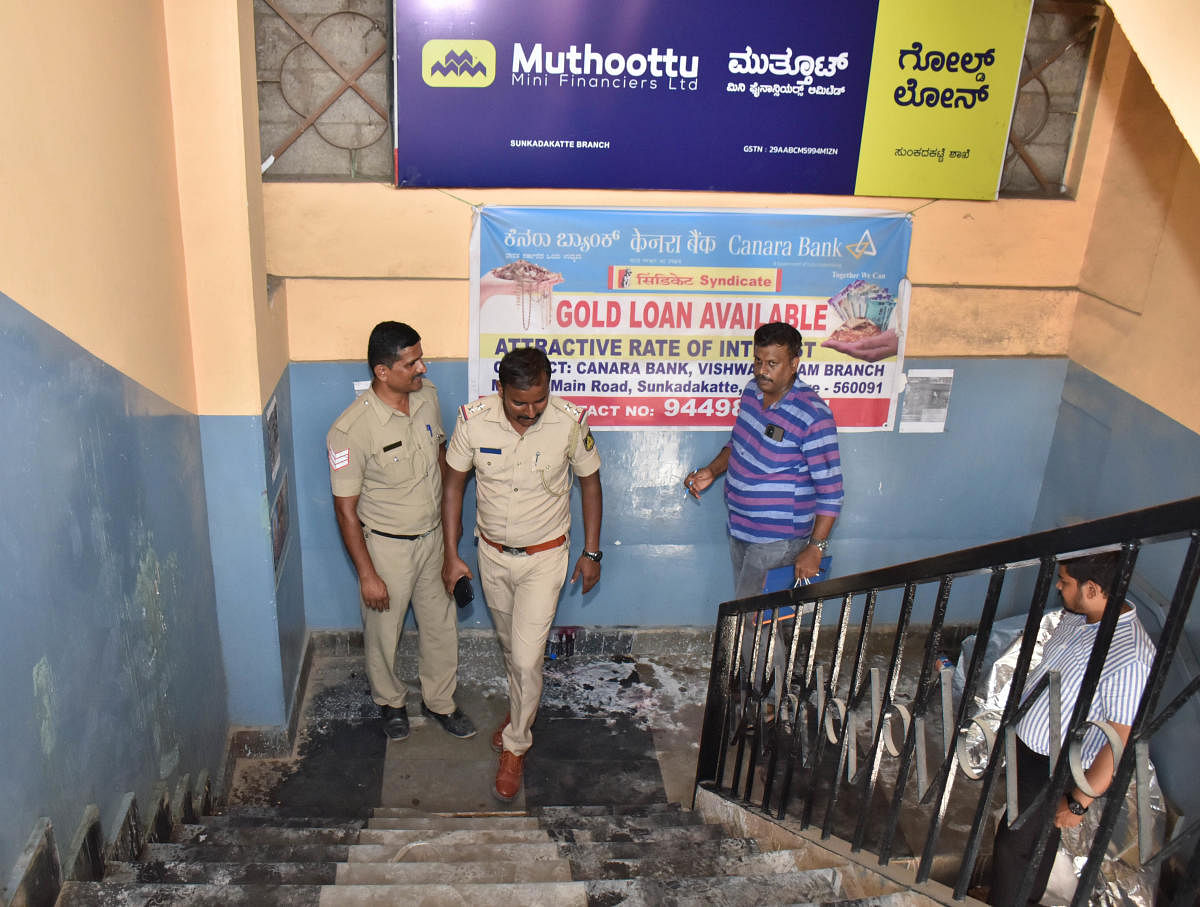 Police examine the staircase of a building in Sunkadakatte where the acid attack happened on Thursday. DH Photo/B K Janardhan