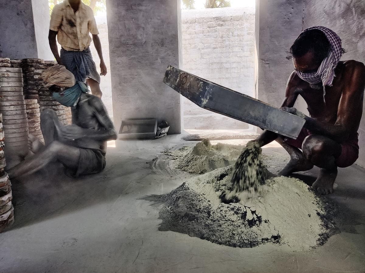 Workers mix chemicals by hand when the day begins. They then pack the mix into round and rectangular trays and seal with soil, gum and water. Credit: DH Photo