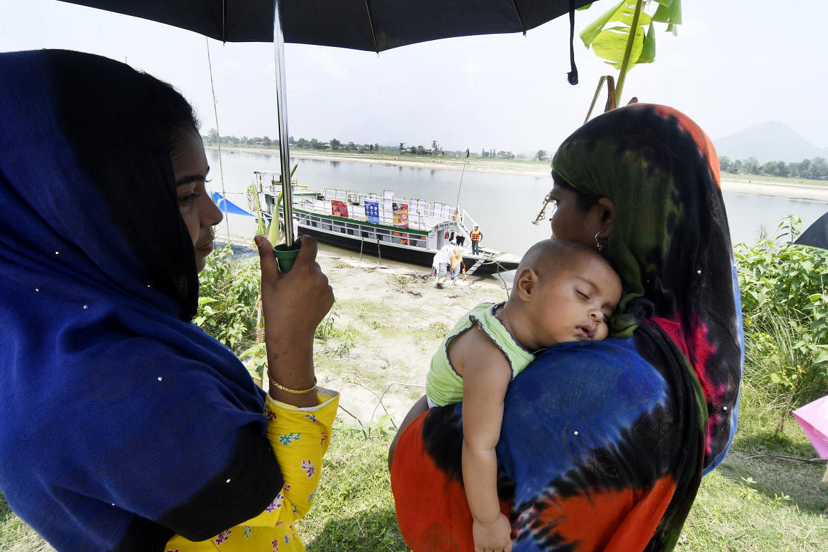 Things have improved. Parents bring children for their shots — immunisation is a key responsibility for boat clinics. Credit: Subhamoy Bhattacharjee
