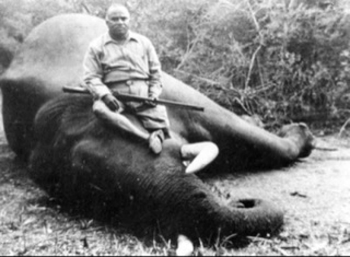 Grandfather sitting on the rogue elephant that he shot and killed.