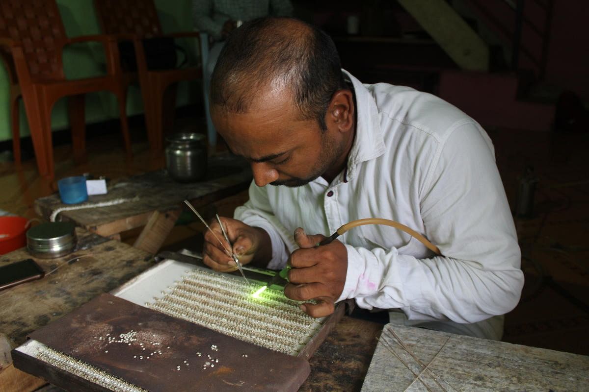 Artisans in Manguru village, Belagavi district working on silver anklets. Photos by author