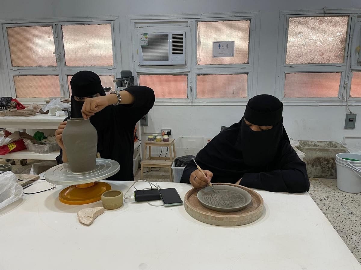 Women learning pottery at the art school in AlUla