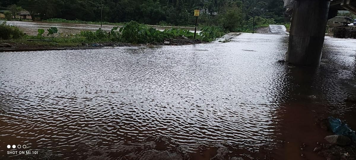 The Napoklu-Bhagamandala Road is inundated following heavy rainfall in the region on Thursday. DH Photo