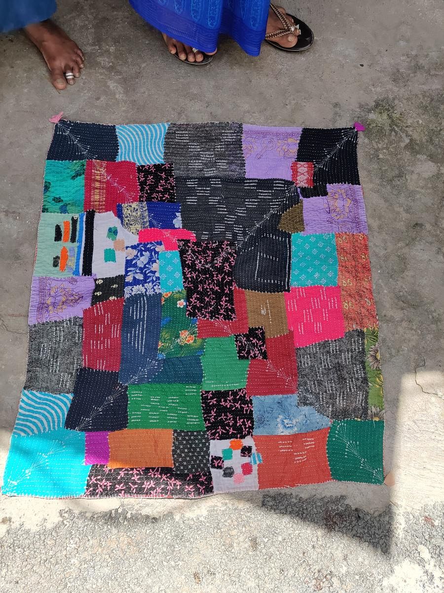 Closeup of baby quilt with thread motifs tottilu gowri