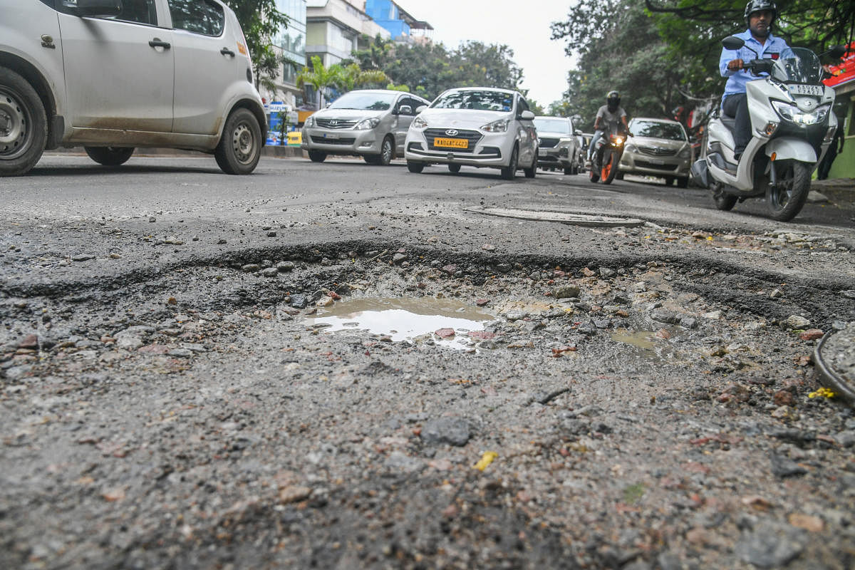 Incessant rain washes away asphalt and damages roads, like this one on KH Road (Double Road). Motorists have nightmarish experiences on such stretches. Credit: DH Photo/S K Dinesh