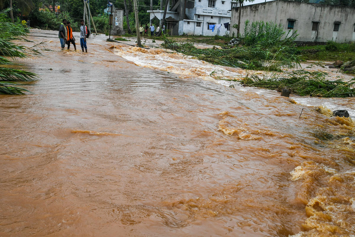 The road in Basavanapura village of Ramanagara district gets submerged following lake breach. Credit: DH Photo/S K Dinesh