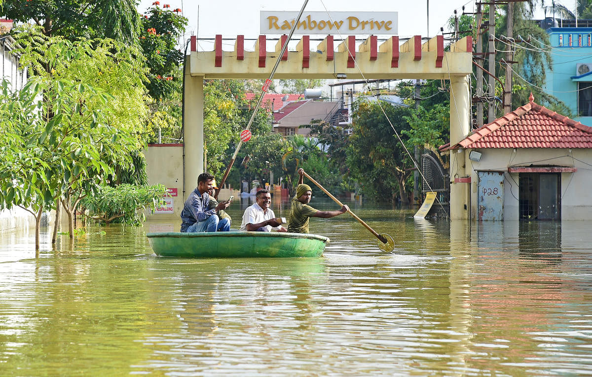 Residents of Rainbow Drive Layout on Sarjapur Road use a coracle to get around. DH Photo/Ranju P