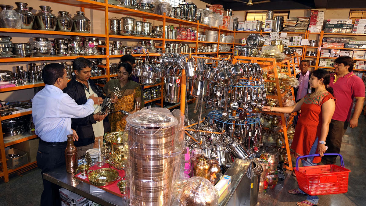 Customers buying household products at a supermarket developed by a cooperative in Sirsi.