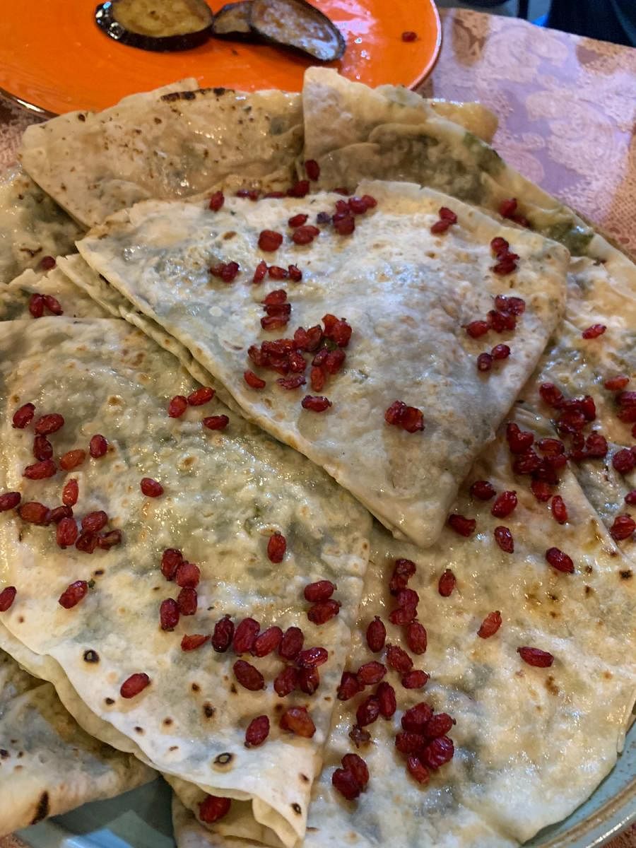 Gutab, a signature Azeri dish stuffed with meat, herbs, chestnuts or pumpkin, and topped with cheese and pomegranate arils.