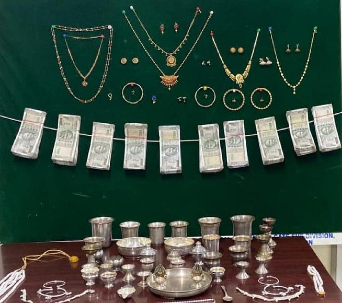 The booty recovered from the accused, Umadevi. The stolen valuables are valued at Rs 15 lakh. These include 230 grams of gold jewellery, 750 grams of silver articles and Rs 5 lakh in cash. Credit: Special arrangement