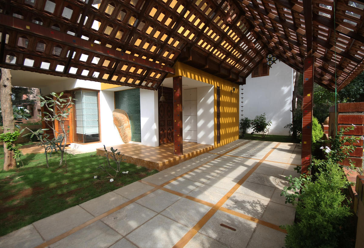 The entry porch and extended deck-cum-parking area at a Bengaluru home by Mistry Architects.