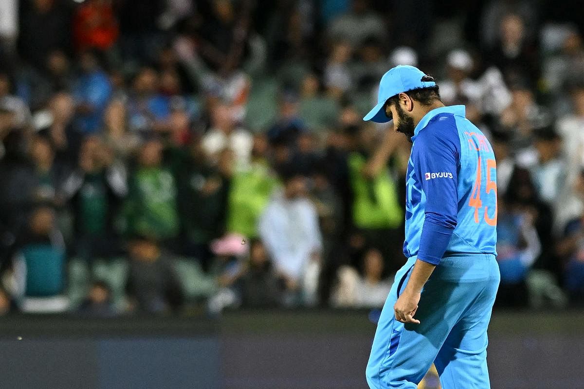 A visibly dejected Indian skipper Rohit Sharma walks off the field after suffering a humbling defeat against England in the semifinals of the World Cup on Thursday. Credit: AFP Photo