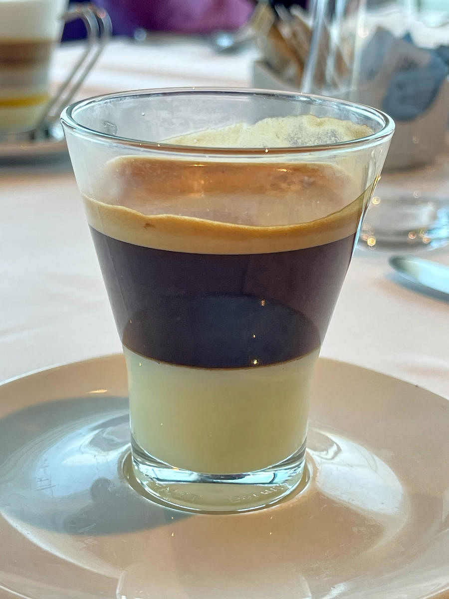 Barraquito, a layered coffee, with a base of condensed milk, espresso, and a shot of Licor 43, frequently follows a meal