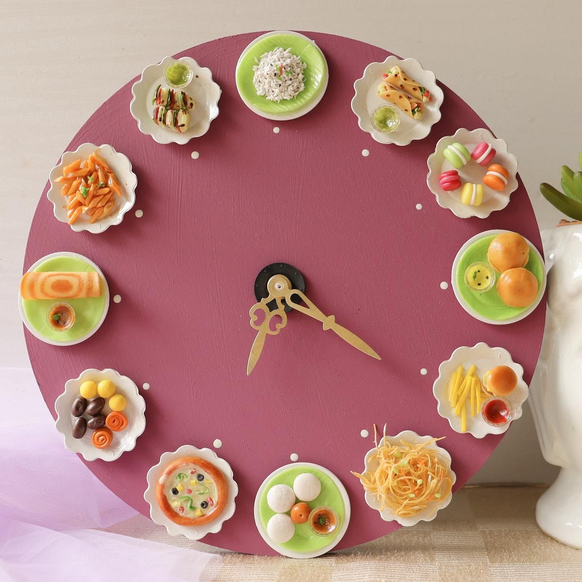 A clock with miniature foods by Uma Gayathri.  