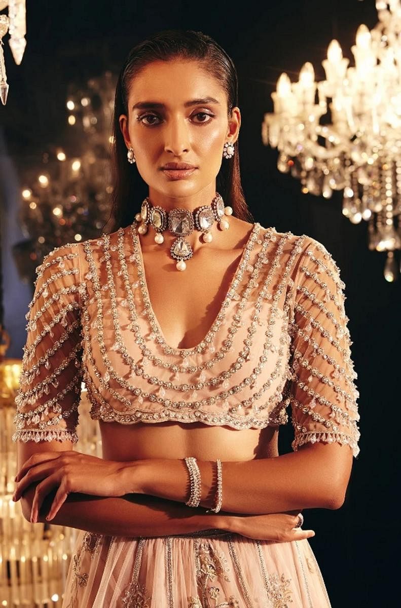 New Delhi-based designer Ridhi Mehra has created a jewelled deep U-neck blouse.