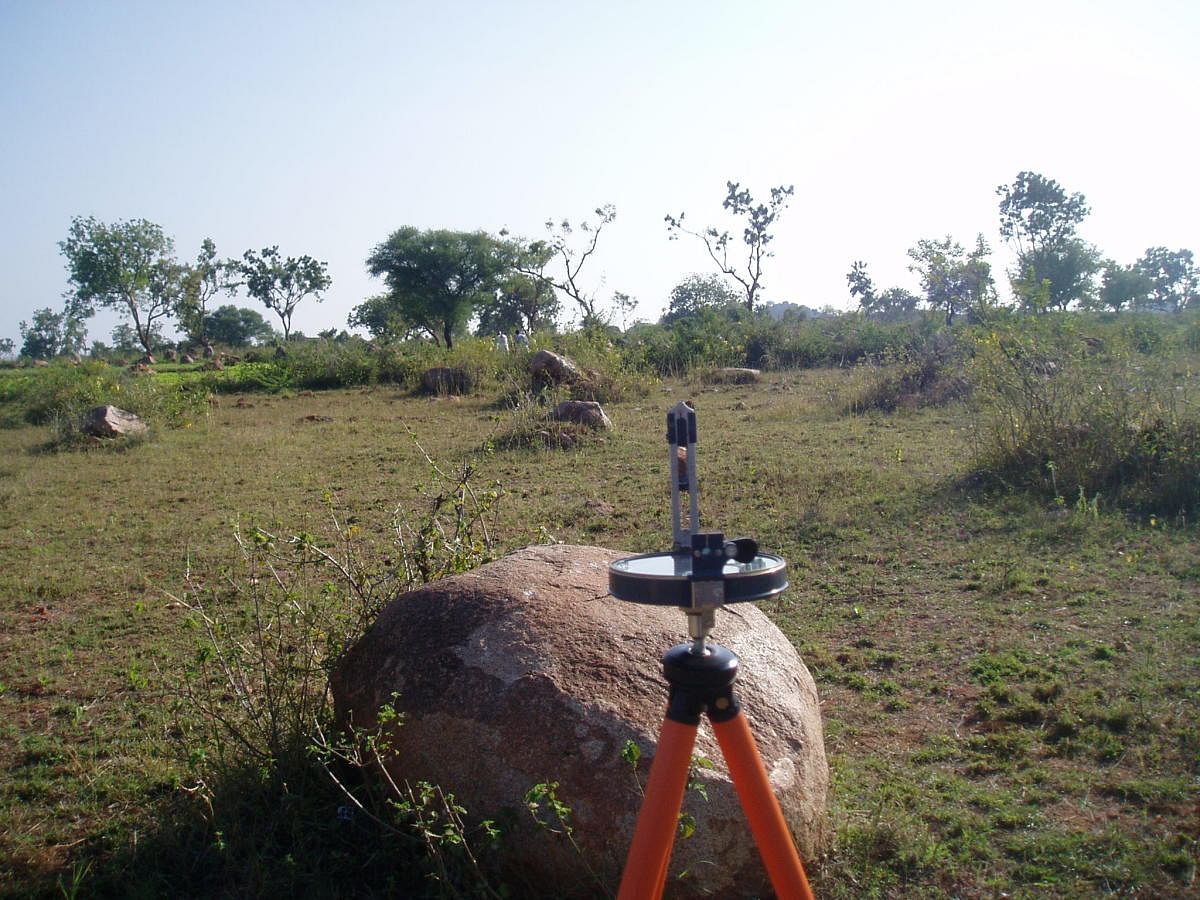 Surveying the stone alignment with a prismatic compass.