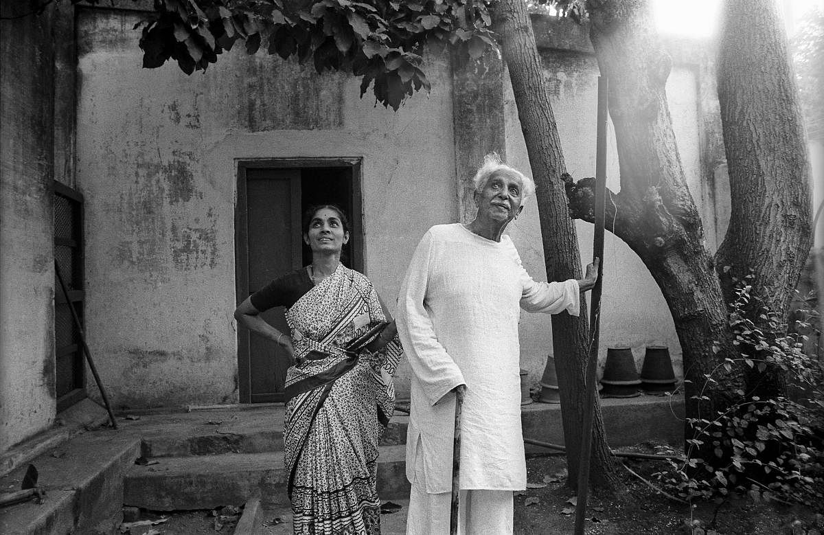 Kuvempu spots a bird outside his house with his daughter.
