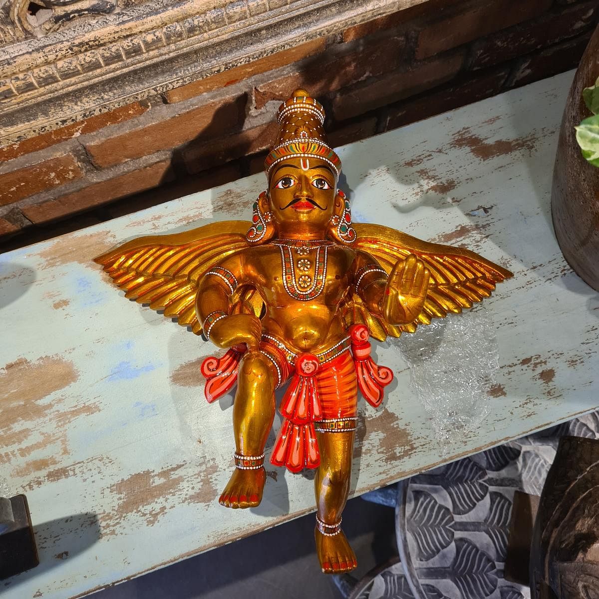 A golden figurine, painted using metallic colours. Photo by Santosh Chitragar