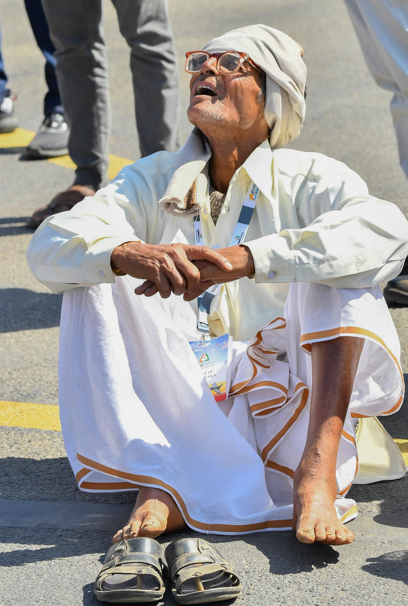 An awe-struck elderly man enjoys the aero show. Credit: Prajavani Photo