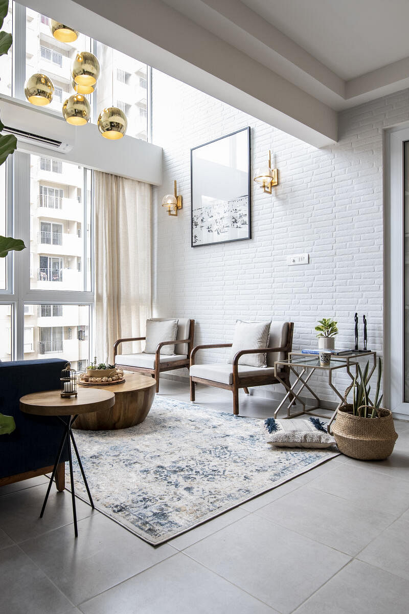 This room by Weespaces has a white and blue palette, with textures like brick, wood, and rattan.