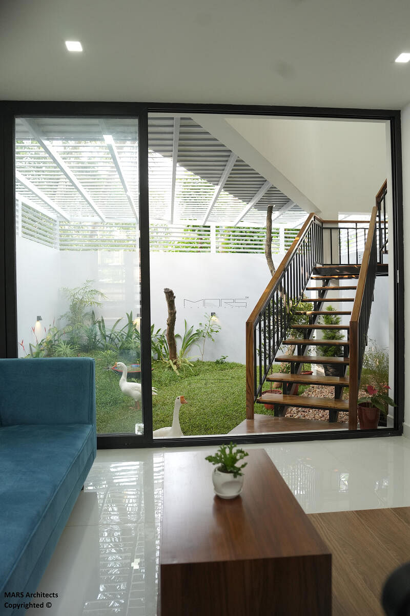 A stairway design through an indoor green space (with a mango tree) by MARS Architects, Bengaluru. 