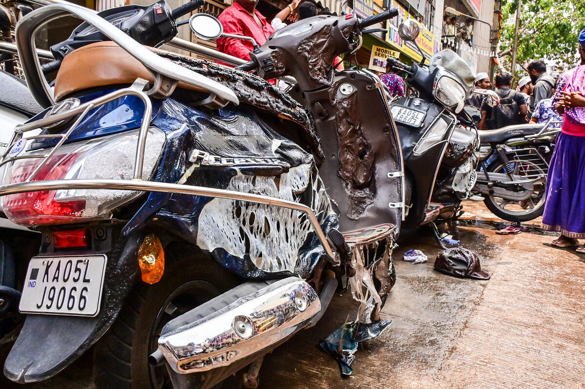 Several vehicles were destroyed after organisers lit camphor blocks on a stretch near the Shri Dharmaraya Swamy temple in Thigalarpet on Thursday. DH PHOTOS/Prashanth H G