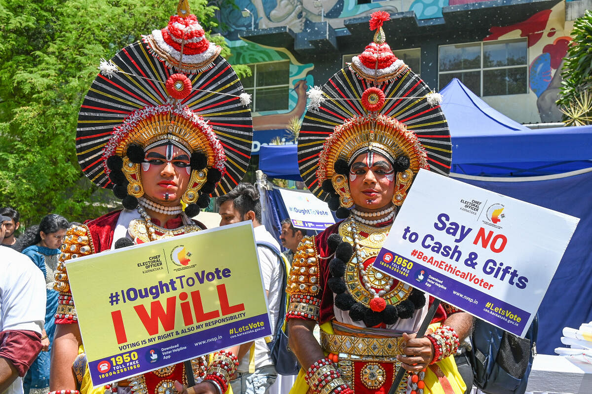 Yakshagana artistes hold placards to create awareness among citizens on the need to exercise franchise in the upcoming assembly elections.