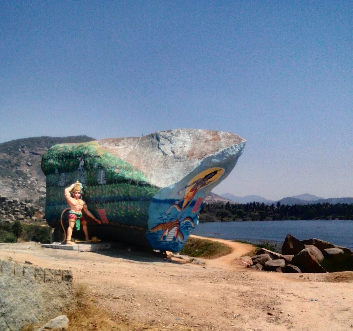 A view of the painted boulder next to the lake.
