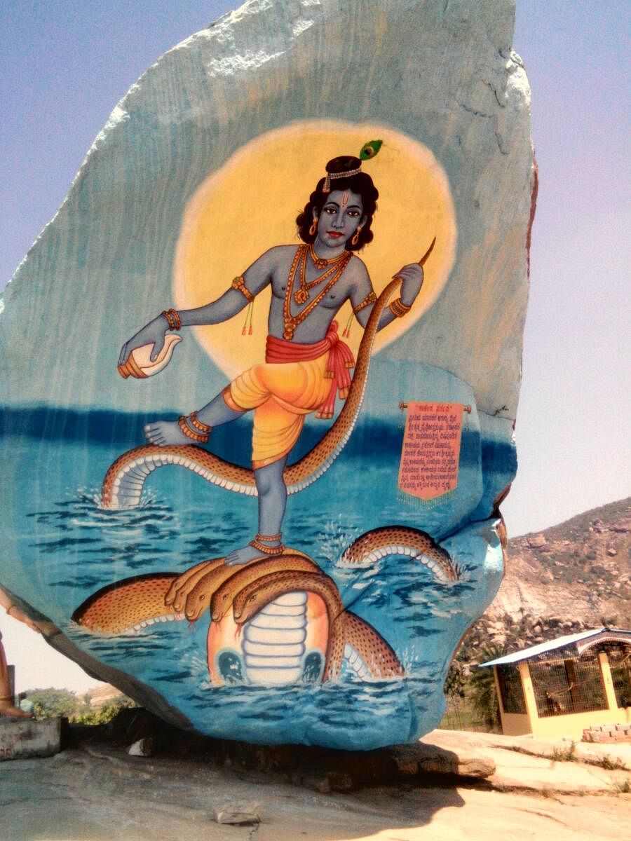 A painting of Krishna on a boulder near the lakeside temple.