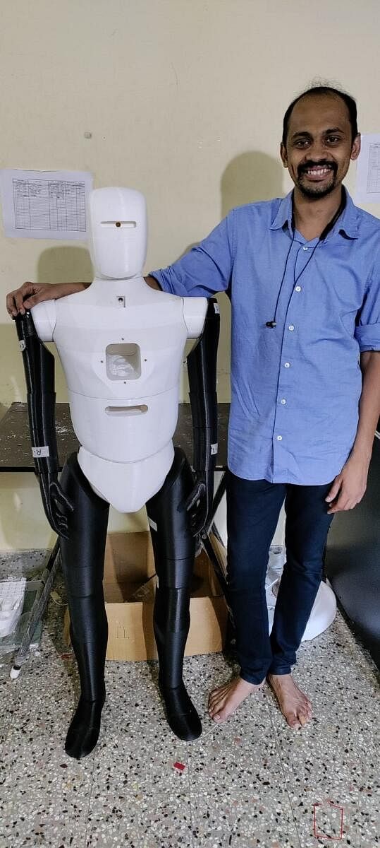 Girish S Murthy with a robotic usher his firm, 3D Printzkart, in JP Nagar, 3D-printed for a college in Dharwad.