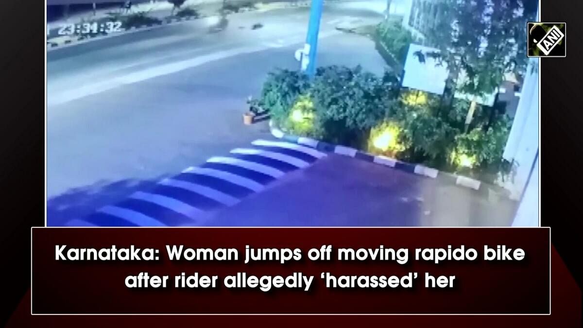 A screengrab from a viral video that shows a woman jumping off a moving bike taxi in Yelahanka, to escape harassment. pic: Special Arrangement