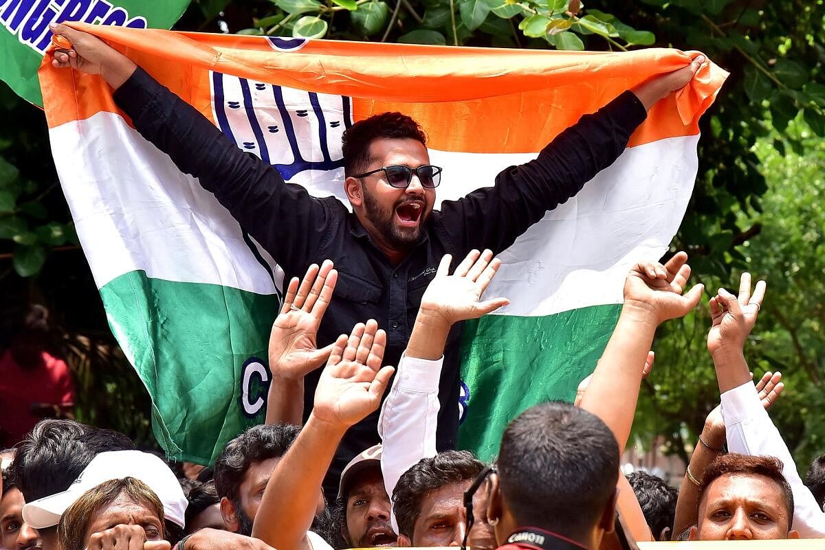 Congress workers celebrate after the party's win in Karnataka Assembly Elections
