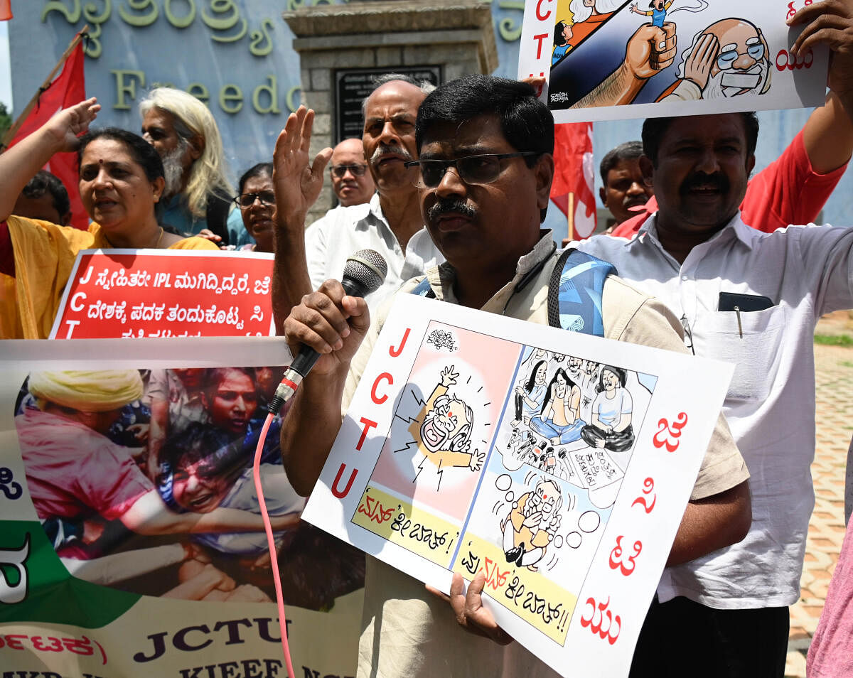 Members of Joint Committee of Trade Unions (JCTU) stage a protest at Freedom Park on Thursday. DH Photo/B K Janardhan