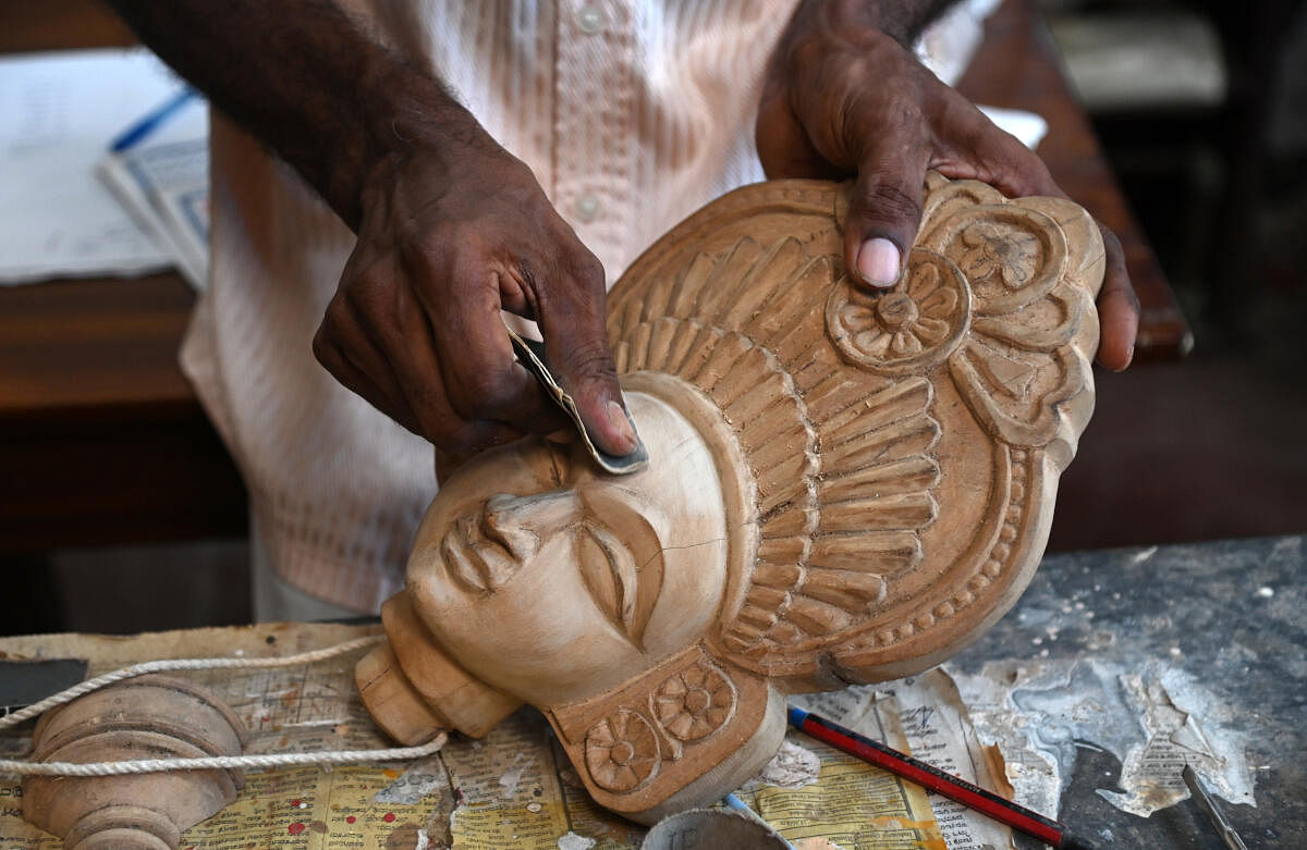 An artist works on a Yakshagana puppet. 