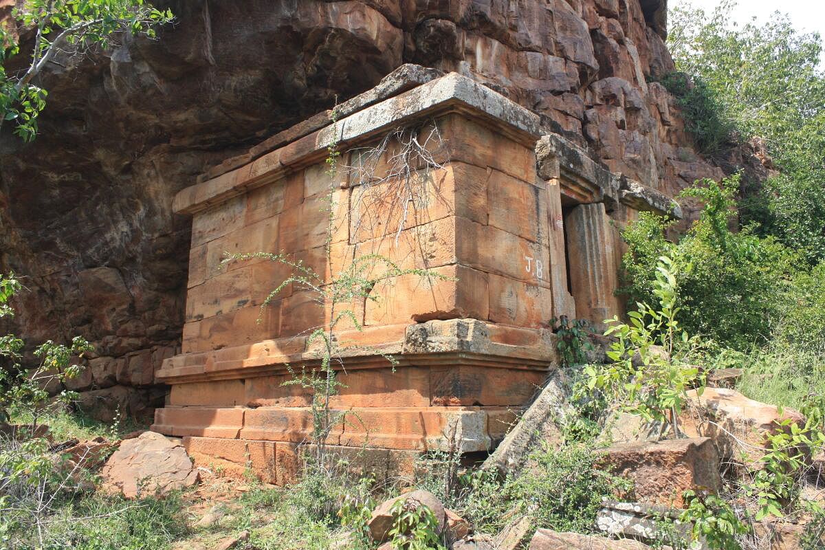 The temple inserted below the overhang of the sandstone cliff.