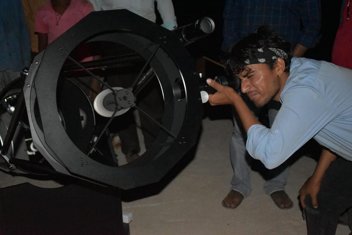Niranjan looks through a 16-inch Dobsonian telescope at the astrofarm. 
