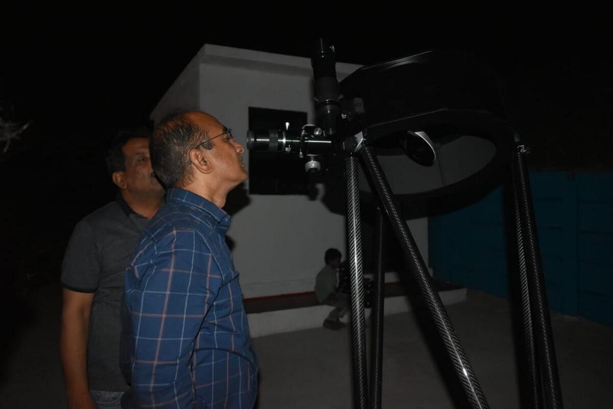 Visitors look through a telescope.