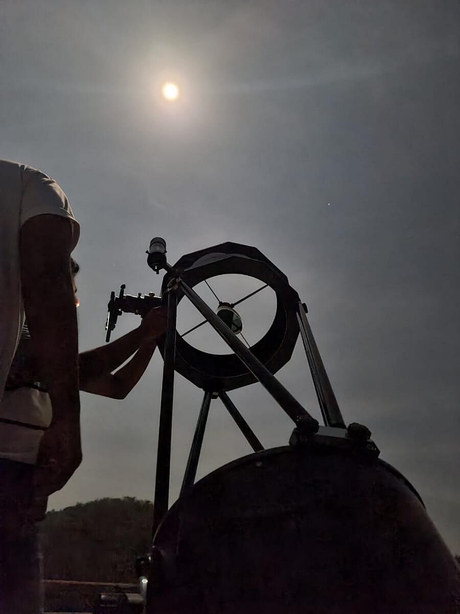 Visitors look at the moon through the Dobsonian telescope.