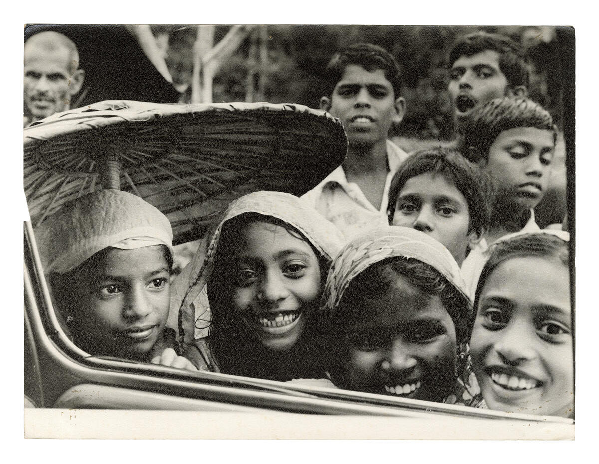 Children smiling at Satyan's camera, Kerala 1980
