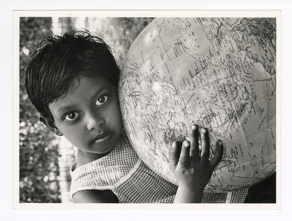 A young girl leaning on a globe, 1973