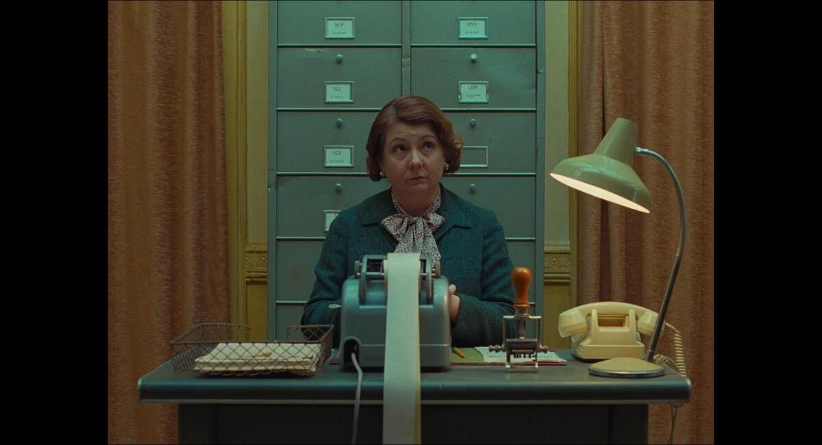 Teal and yellow pastel shades and symmetrical framing in ‘The French Dispatch’ (2021).